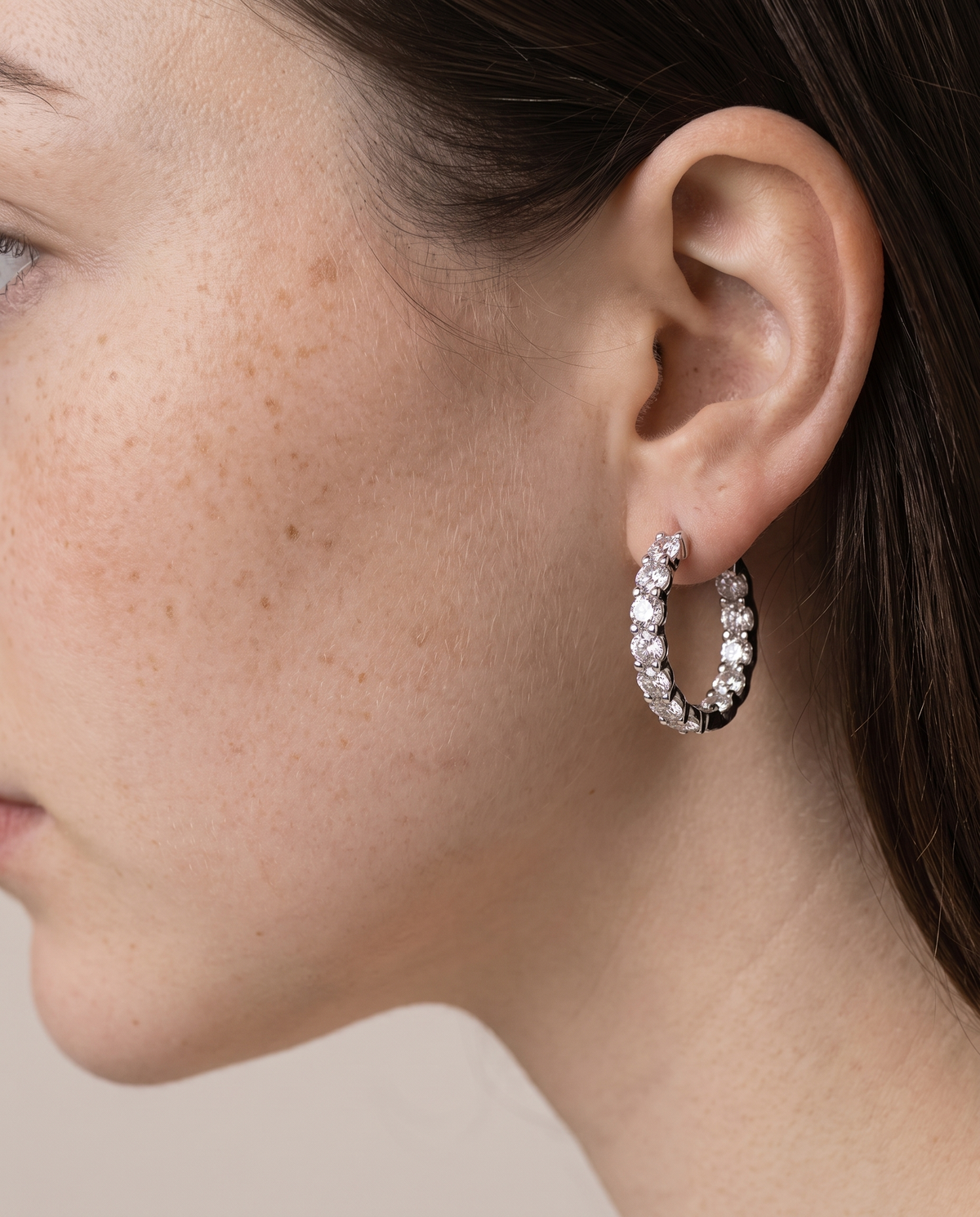 Close-up of a geometric hoop earring, second angle