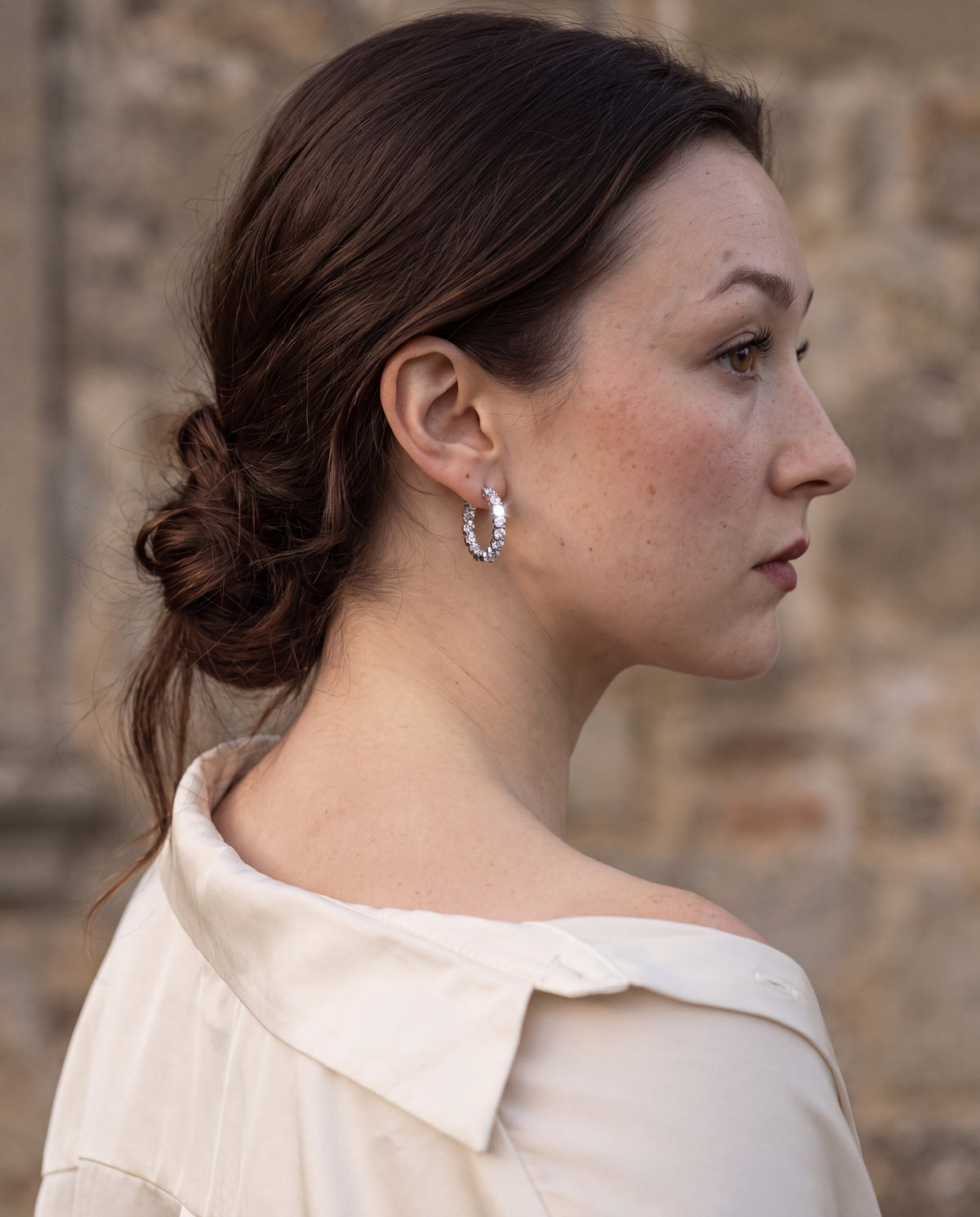 Geometric hoop earring, sterling silver, worn on the ear in profile